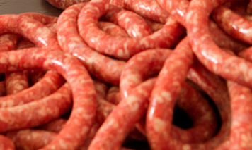 man filling Italian sausages