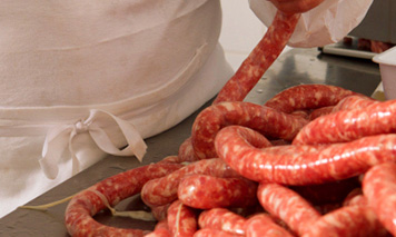 man filling Italian sausages