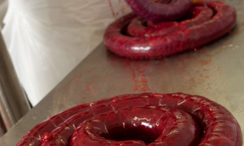 man filling blood sausage