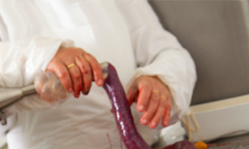 man filling blood sausage